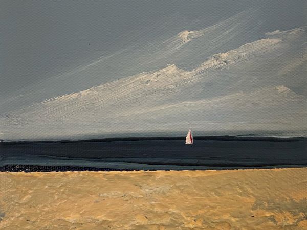 This image depicts a serene beach scene with a sandy shore, a calm sea, and a lone sailboat in the distance under a partly cloudy sky.