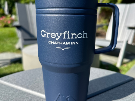 The image shows a blue travel mug with 