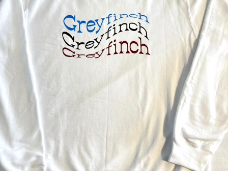 This image shows a white sweatshirt with the word 